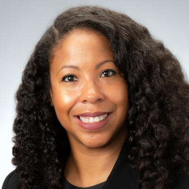 A photo of Dr. Sandra Stinnett, a Black woman with long dark hair.